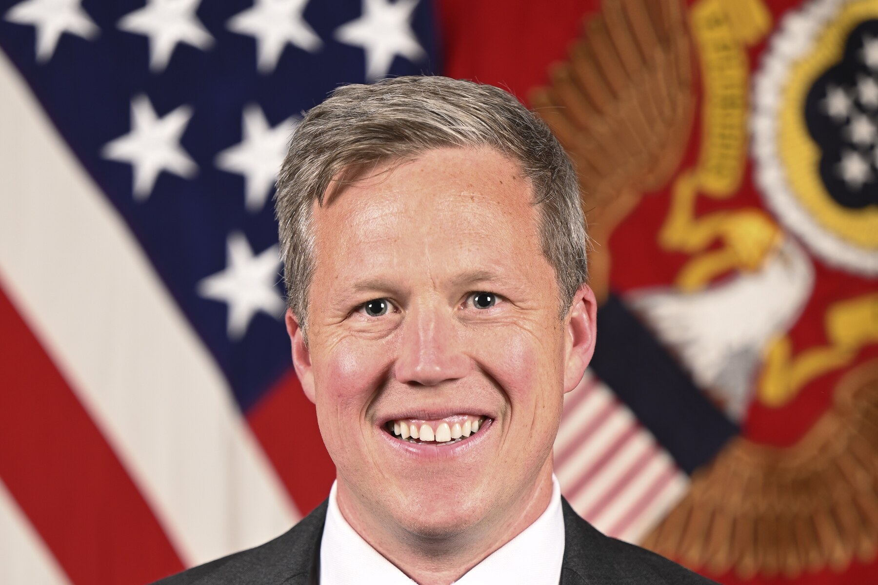 Official portrait of Army Secretary Dan Driscoll in front of the United States and Army flags.