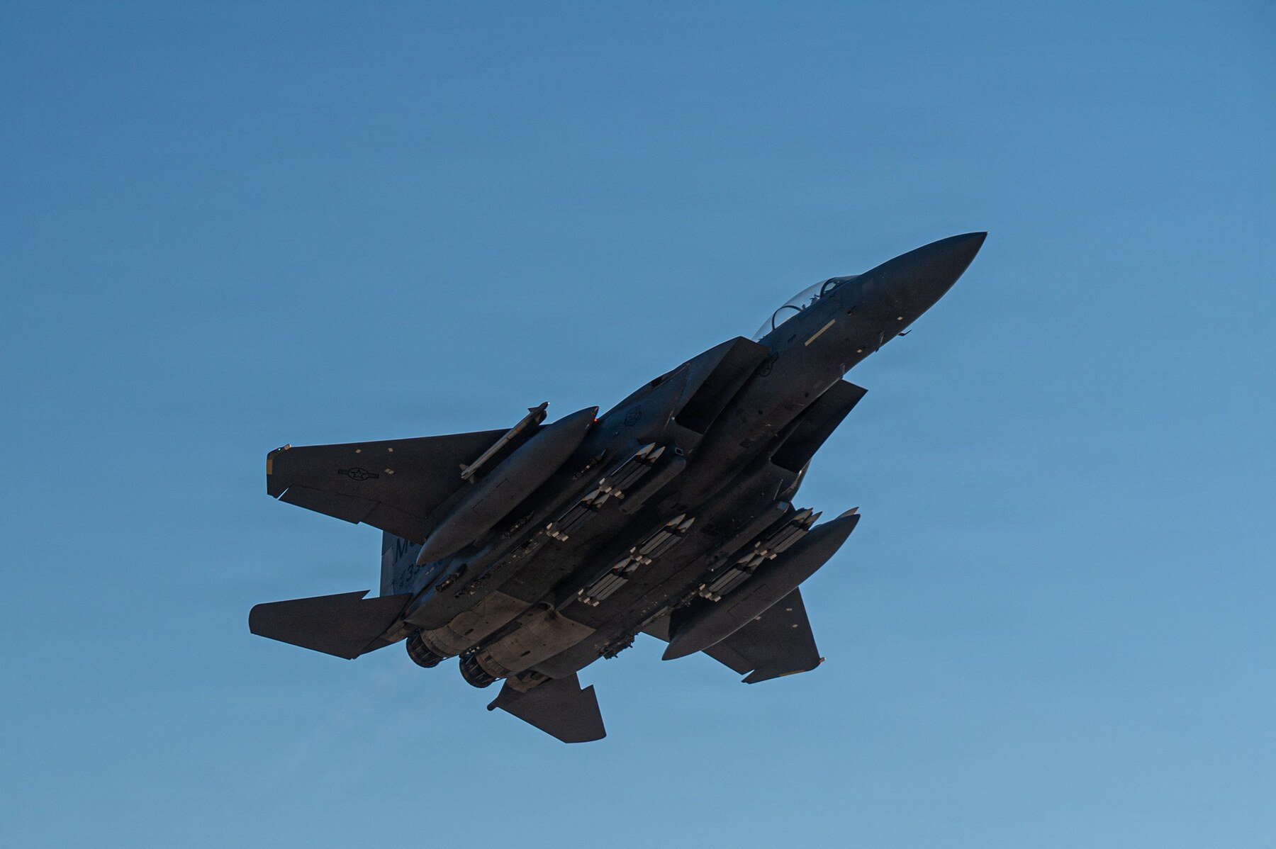 A U.S. Air Force F-15E Strike Eagle climbs into a clear blue sky while operating in the U.S. Central Command region in July 2026.